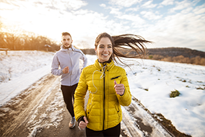 Couple running outside in winter months